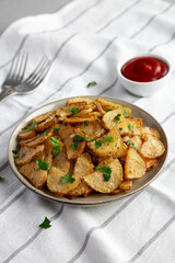 Homemade Roasted Garlic Parmesan Potatoes on a Plate, side view.