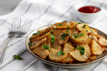 Homemade Roasted Garlic Parmesan Potatoes on a Plate, side view.