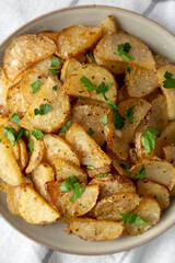 Homemade Roasted Garlic Parmesan Potatoes on a Plate, top view. Flat lay, overhead, from above. Close-up.