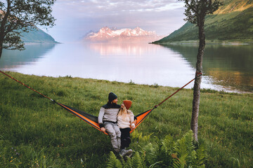 Romantic couple relaxing in hammock outdoor man and woman traveling together in Norway family lifestyle camping summer vacations boyfriend and girlfriend romantic holidays, love Valentines day