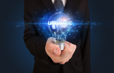 Businessman holding a light bulb