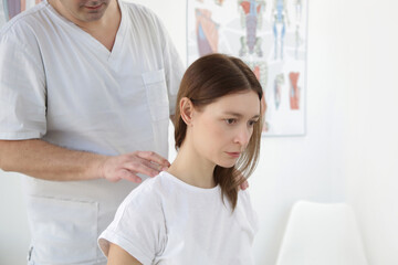 Fototapeta premium Woman at the doctors office on chiropractic, physiotherapy or myodynamic treatment to treat and prevent musculoskeletal problems, reduce pain and muscle tension.