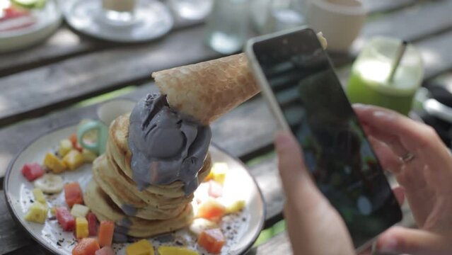 taking pictures of a stack of ice cream pancakes