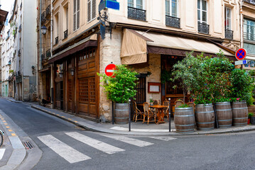 Parisian street with tables with tables of cafe in Paris, France. Architecture and landmark of Paris. Cozy Paris cityscape