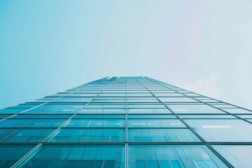 Fototapeta premium A stunning view of a glass-clad building reflecting the sky, showcasing modern design and environmental integration