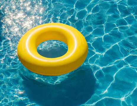 Yellow inflatable ring floating in blue swimming pool water, top view