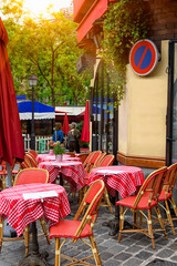 Cozy street with tables of cafe in quarter Montmartre in Paris, France. Architecture and landmarks of Paris. Postcard of Paris - 764834565