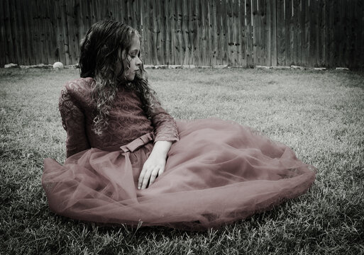 Monochrome Black and white girl in a red dress side face view sitting