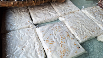Fermenting soybeans into tempeh in plastic wrapped, sell in traditional market.