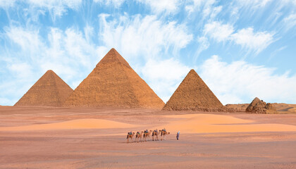Camel caravan in front of the Great pyramid of Giza complex - Cairo, Egypt