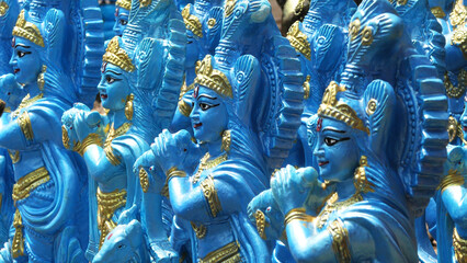 Colorful statues of Lord Krishna displayed in a shop