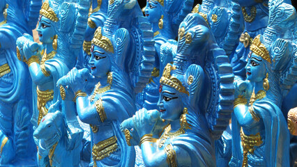 Colorful statues of Lord Krishna displayed in a shop - obrazy, fototapety, plakaty