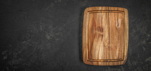 wooden kitchen board on a dark background