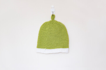 Baby knitted green and white tea cosy style hat