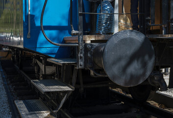 train wagon on rails, blue metal, ladder, entrance to railroad car