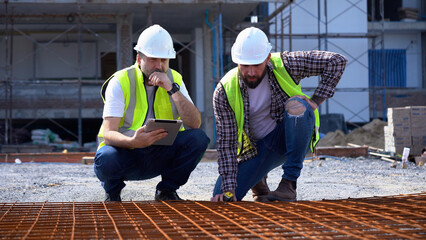team of Construction workers Senior architect or civil engineer and foreman discussion to inspection or checking structure steel rebar for precast concrete slabs at construction site. building project
