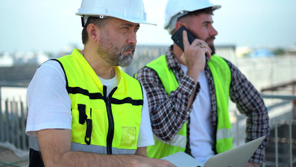 team of Construction workers Senior architect or civil engineer and foreman walking and discussion...