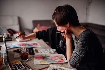 Fototapeta premium Two artists in sync, immersed in a painting session on a cozy afternoon, their collaboration painting a picture of focused creativity