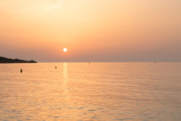 A magical sunsets with orange skies at the ocean