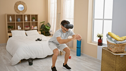 A young man experiences virtual reality in a modern bedroom setting, showcasing technology in...