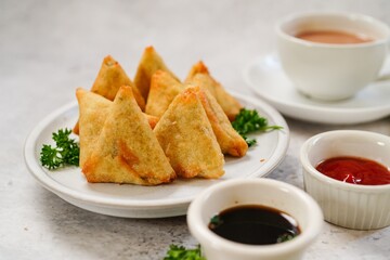 Homemade mini cocktail samosa | Indian appetizer served with ketchup and tamarind sauce