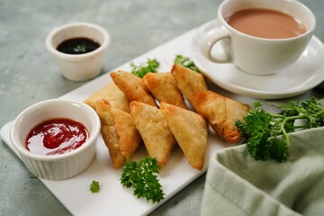 Homemade mini cocktail samosa | Indian appetizer served with ketchup and tamarind sauce