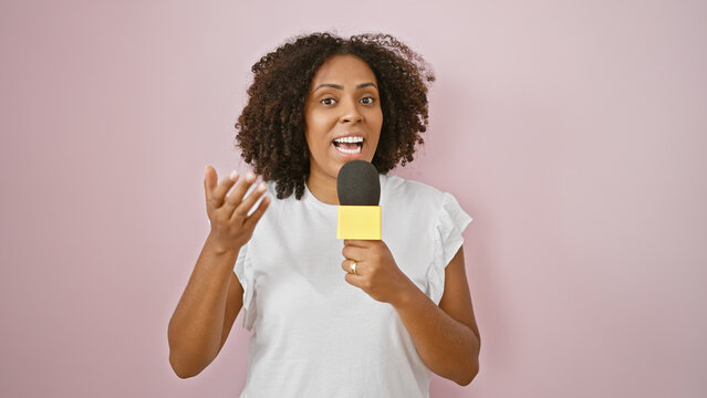 Black Woman With Microphone Over Pink Background