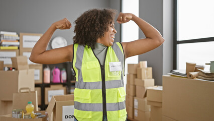 African american woman volunteer celebrating in warehouse