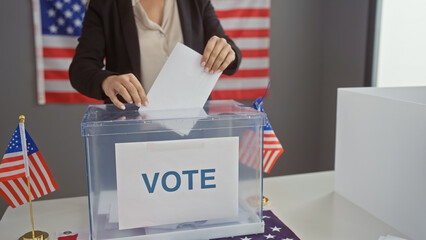 Hispanic woman voting in an american election, showcasing democracy and citizenship in an indoor...