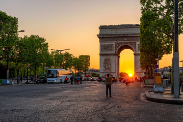 Paris Arc de Triomphe (Triumphal Arch) in Champs Elysees at sunset, Paris, France. Cityscape of...