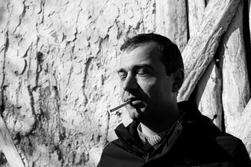 Portrait of a young man smoking cigarette	