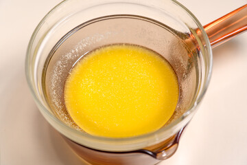 Melted butter in glass bowl over a pot of hot water. Cooking Salted Caramel Chocolate Cold Cake Series.
