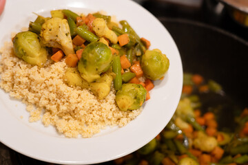 Plate of couscous served with fried vegetables
