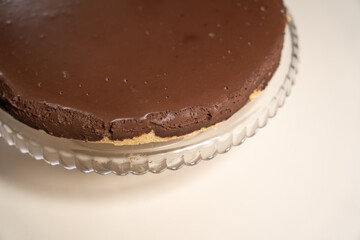 Chilled cake on pressed glass cake stand ready to decorate. Cooking Salted Caramel Chocolate Cold Cake Series.