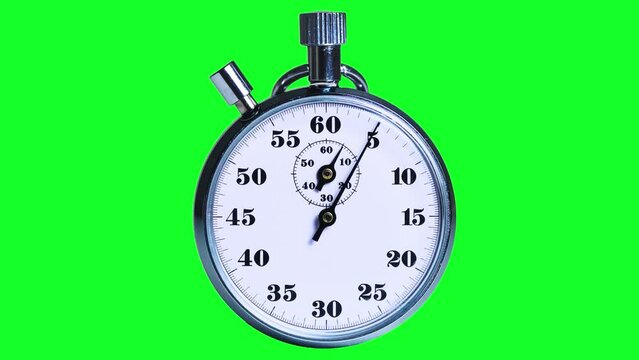 Analog metal stopwatch counts down a munute on a green background. Real vintage clock with a moving hand on the dial. ootage for chromakey. High quality 4k footage