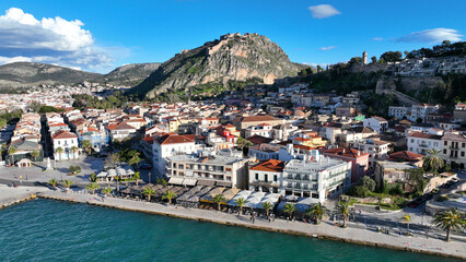 Fototapeta na wymiar Aerial drone photo of beautiful landmark castle of Palamidi built uphill overlooking iconic city of Nafplio in a nice spring morning with white clouds and deep blue sky, Argolida, Peloponnese, Greece