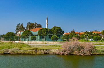 Kadincik river and minaret of Orjan mosque (Burhaniye, Balikesir province, Turkey)