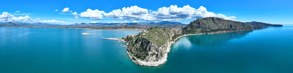Foto auf Leinwand Aerial drone photo of iconic Acronafplia fortress overlooking old city of Nafplio below famous castle of Palamidi as seen in a spring morning with beautiful clouds and deep blue sky, Argolida, Greece © aerial-drone
