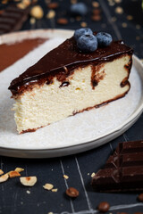 Cheesecake slice with melted and crushed chocolate