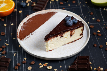 Cheesecake slice with melted and crushed chocolate