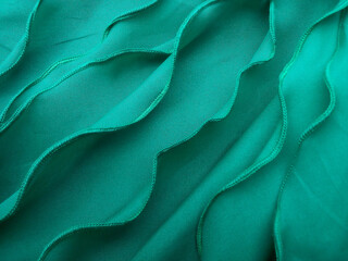 a collection of thin green cotton cloth with wavy edge stitching. background of pile of thin sewing...