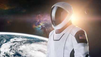 Spaceman in outer space on Earth planet background. Exploration theme. Elements of this image...