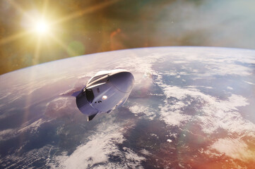 Cargo spacecraft in low-Earth orbit with sunlight. Elements of this image furnished by NASA.