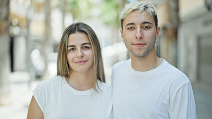 Fototapeta premium Beautiful couple smiling confident standing together at street