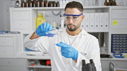 A man in a lab coat examines a chemical sample in a hospital laboratory