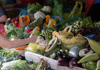 Shopping for veg on a market stall.