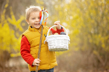 Cute preschool child, boy, holding handmade braided whip made from pussy willow, traditional symbol...