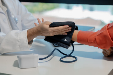 Doctors are giving blood pressure measuring devices to check people's pulses and blood pressures to see if they are within the specified limits or not, A doctor examines a patient.