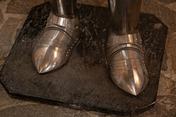 The lower part of the plates to protect the legs of a knight's armor.