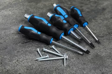 Foto op Plexiglas Set of screwdrivers and screws on grey table © New Africa